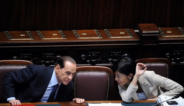 Silvio Berlusconi shows a newspaper to Mara Carfagna